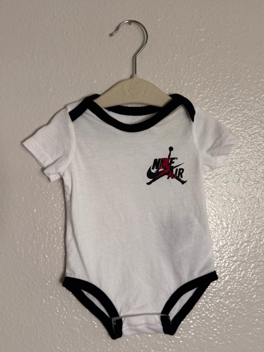 Jordan White One-Piece Bodysuit with Black Trim
